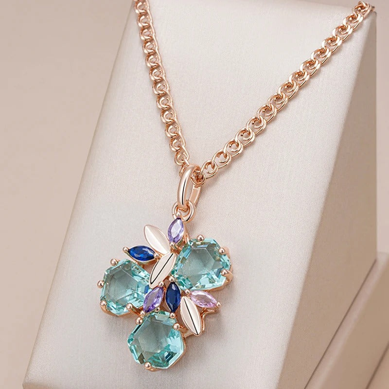 Necklace with tropical flower pendant with aquamarine zirconia and sapphire, amethyst and rose quartz in 18K rose gold plating