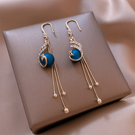 Peacock-inspired blue pearl earrings