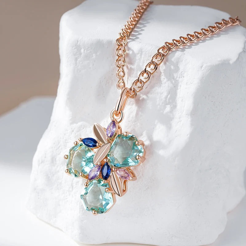 Necklace with tropical flower pendant with aquamarine zirconia and sapphire, amethyst and rose quartz in 18K rose gold plating