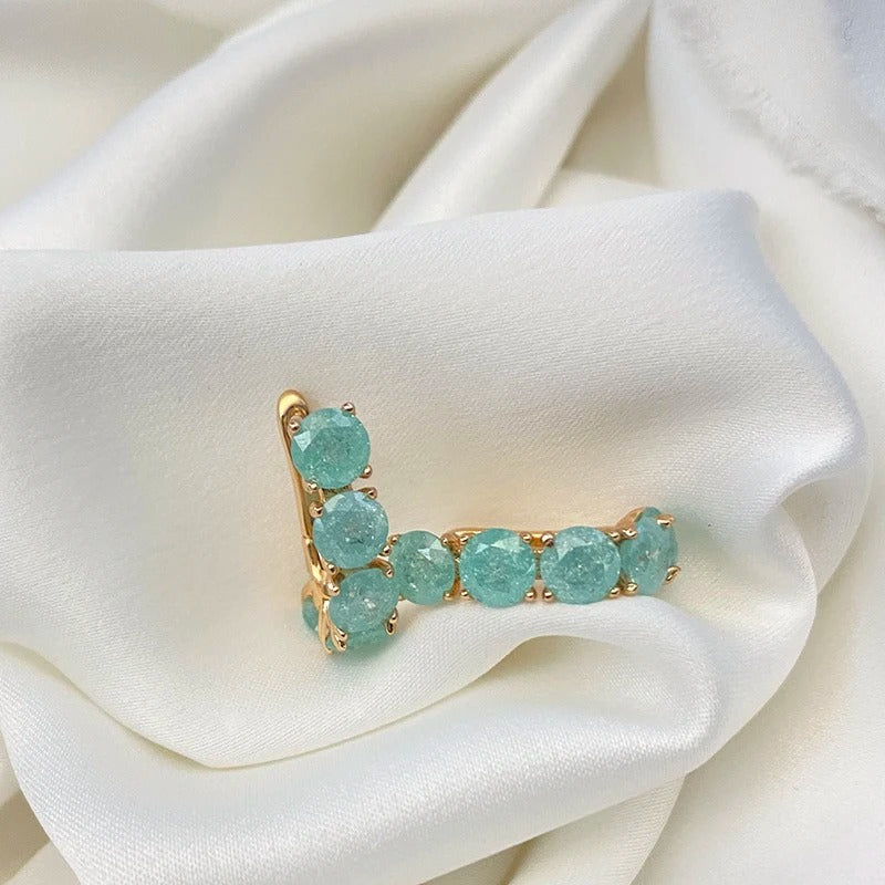 Hoop earrings filled with aquamarine zirconias in 18K Rose Gold Plating