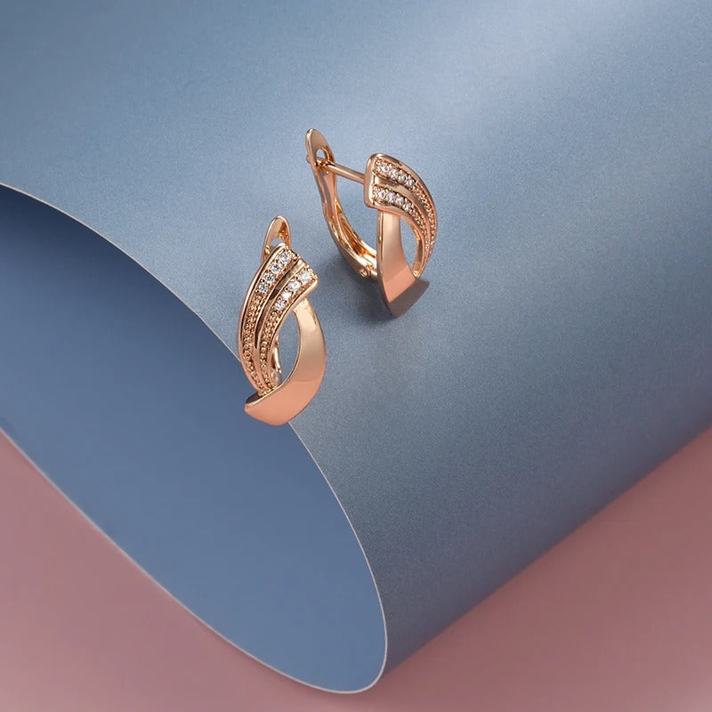 Geometric shaped button earrings with small zirconia stones in 18K rose gold plating