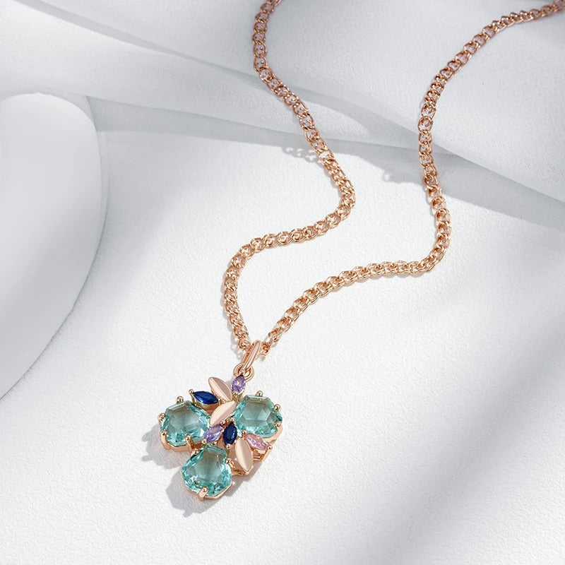 Necklace with tropical flower pendant with aquamarine zirconia and sapphire, amethyst and rose quartz in 18K rose gold plating