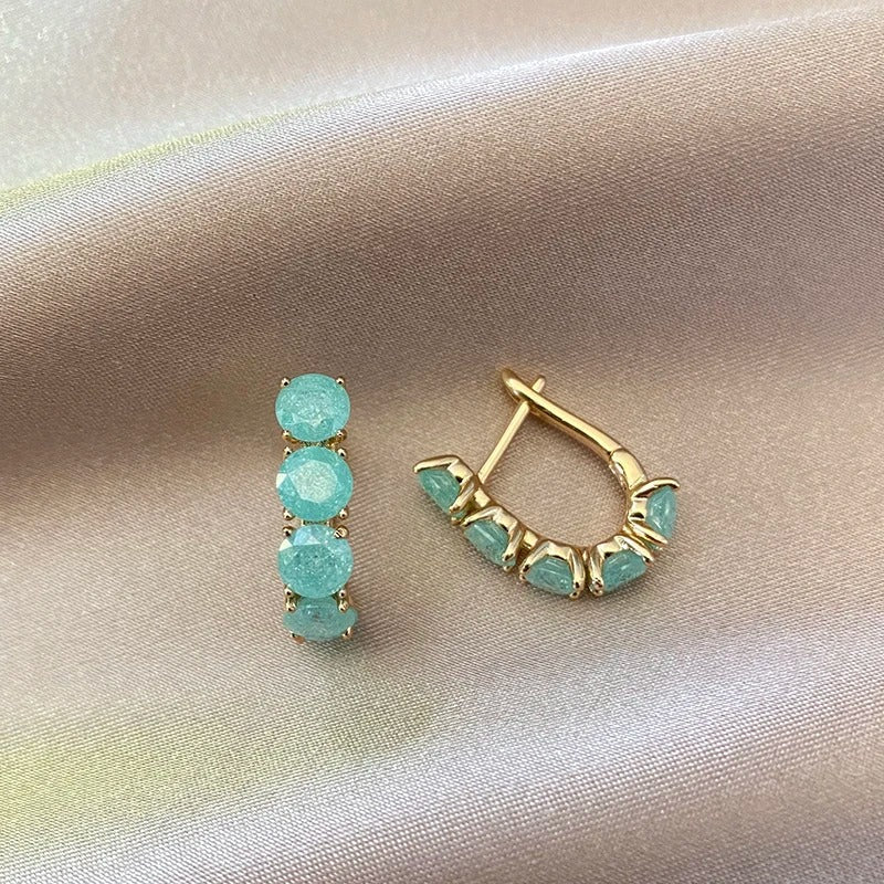 Hoop earrings filled with aquamarine zirconias in 18K Rose Gold Plating